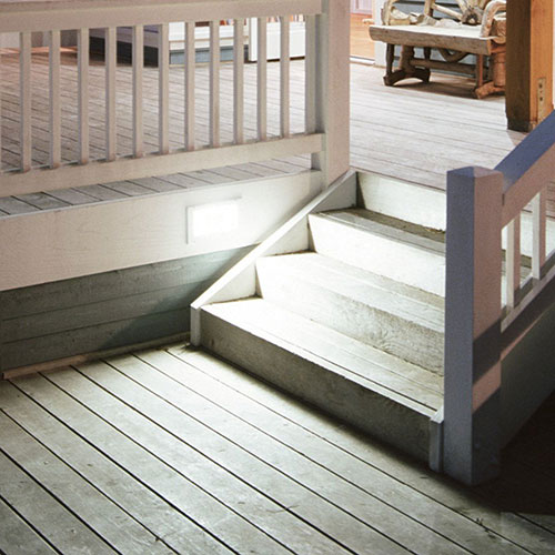 Wooden deck with stairs and lighting