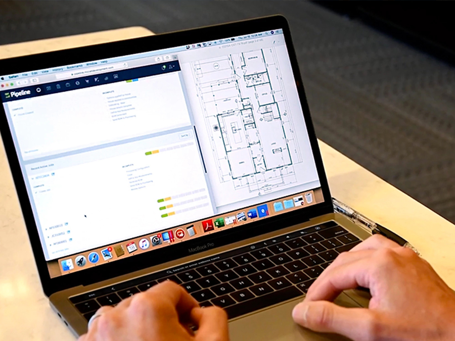 Engineer looking at Strong-Tie software on laptop.