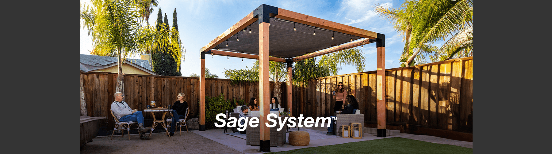People enjoying a stylish backyard pergola built with the Sage System™ by Simpson Strong-Tie, featuring wooden posts, modern accents, and cozy seating.