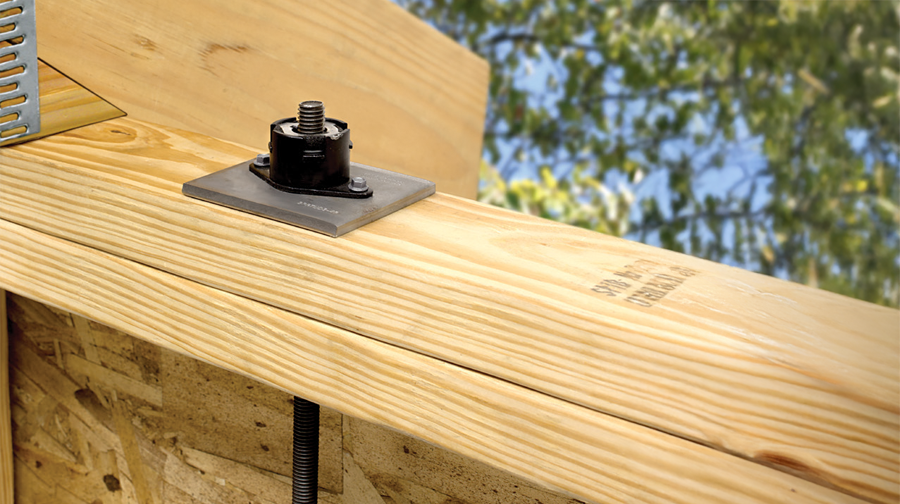 Uplift Restraint System (URS) installed within wooden framing system.