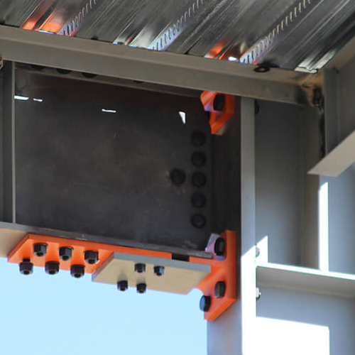 The Yield-Link® Moment Connection is shown at a beam-column joint, highlighting its bolted, replaceable design to enhance seismic performance in steel buildings.